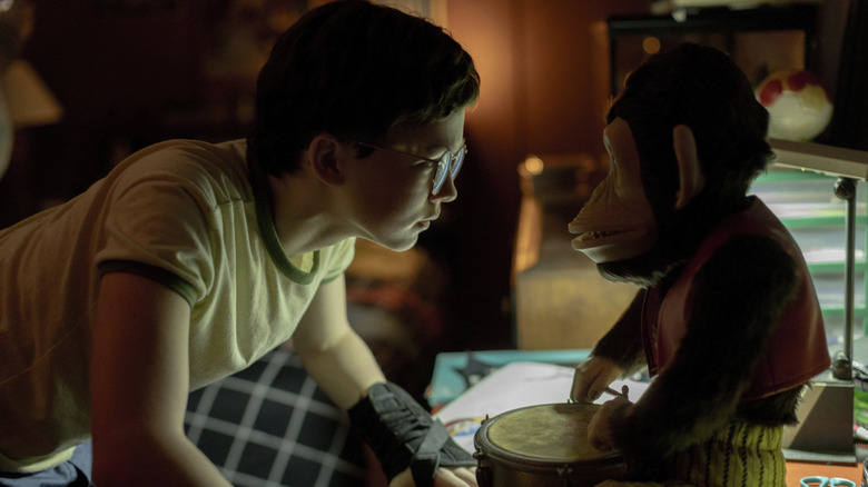 Young Hal looking at a haunted monkey toy in his room