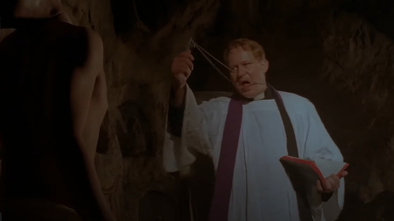 Father Merrin performing exorcism