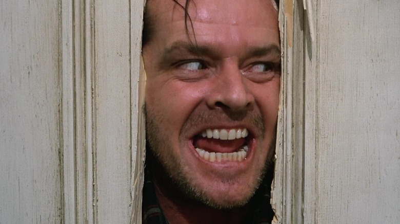 Jack Torrance, poking his head through the opening of a broken door, reciting a line from an old TV show in The Shining