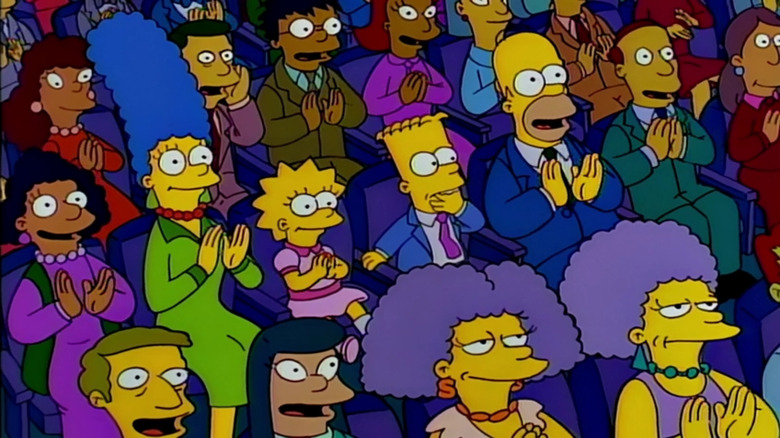 Homer applauding the Planet of the Apes musical in The Simpsons