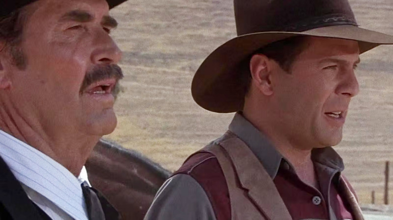 Jamesiyes Garner like Wyatt Erp and Bruce Willis as Tom Mix looking at the sunset screen at sunset