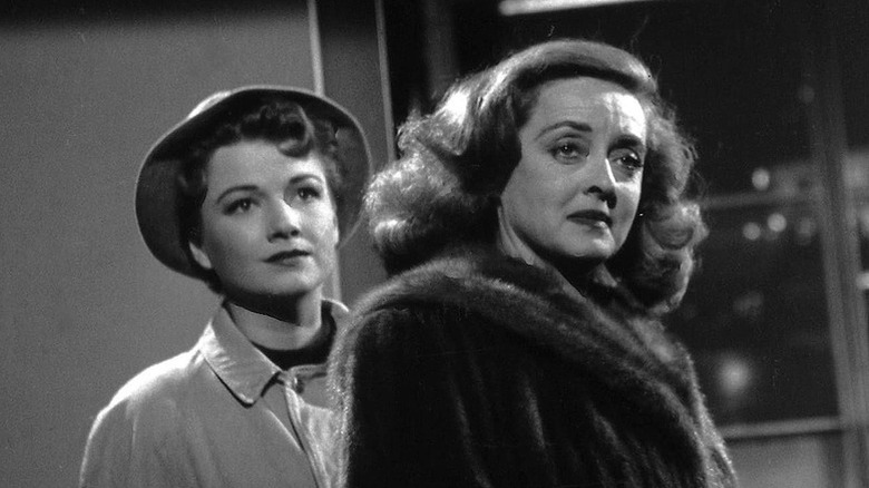 Eve wearing a hat and Margo wearing a fur in All About Eve