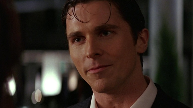 Christian Bale as Bruce Wayne looking thoughtful in Batman Begins