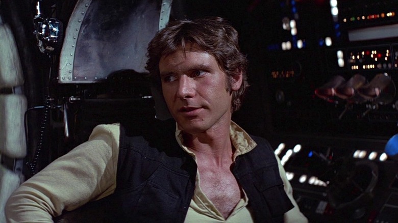 Harrison Ford as Han Solo sitting in the Millennium Falcon in Star Wars: A New Hope