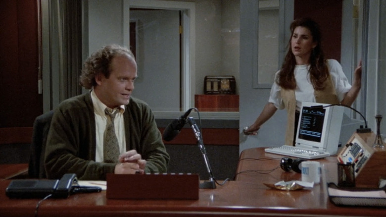 Kelsey Grammer's Frasier Crane and Peri Gilpin's Roz Doyle stand in a radio studio in Frasier