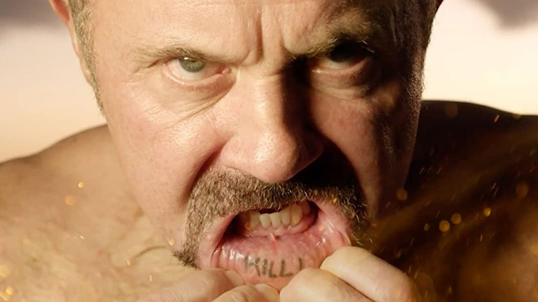 Kane Hodder shows off a lip tattoo in the documentary To Hell and Back: The Kane Hodder Story