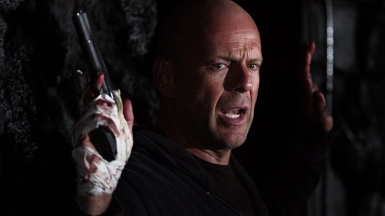 Bruce Willis puts his hands in the air as Jeff Talley in Hostage