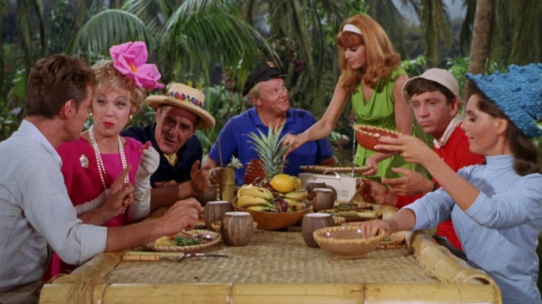 The seven castaways of Gilligan's Island gathered around a table for a fruit salad dinner.