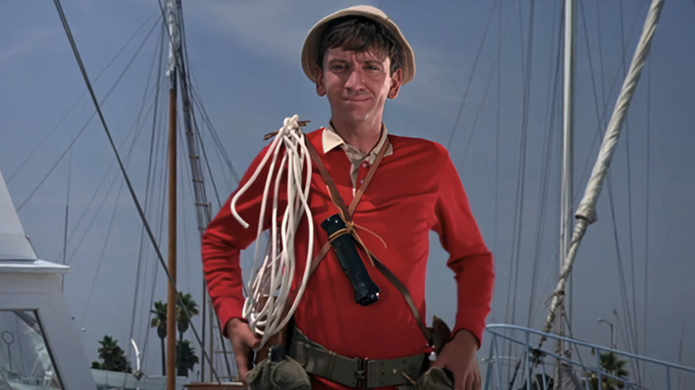 Bob Denver's Willy Gilligan stands straight up wearing hi classic red sweater in Gilligan's Island