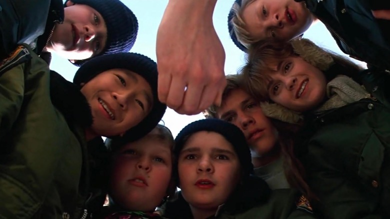 The Goonies looking down at the treasure in Mikey's mom's hand in The Goonies