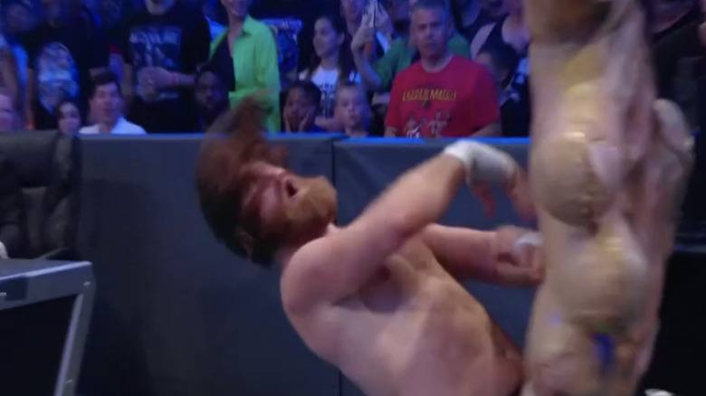 Sami Zayn gets slapped by a comically large hand