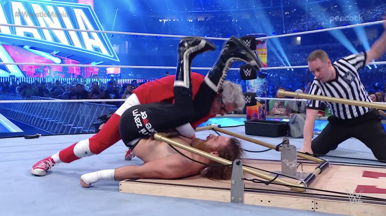 Johnny Knoxville pins Sami Zayn with the help of a mousetrap.