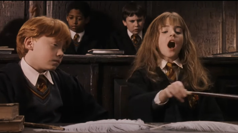 Rupert Grint as Ron Weasley and Emma Watson as Hermione Granger in Harry Potter and the Philosopher's Stone (2001)