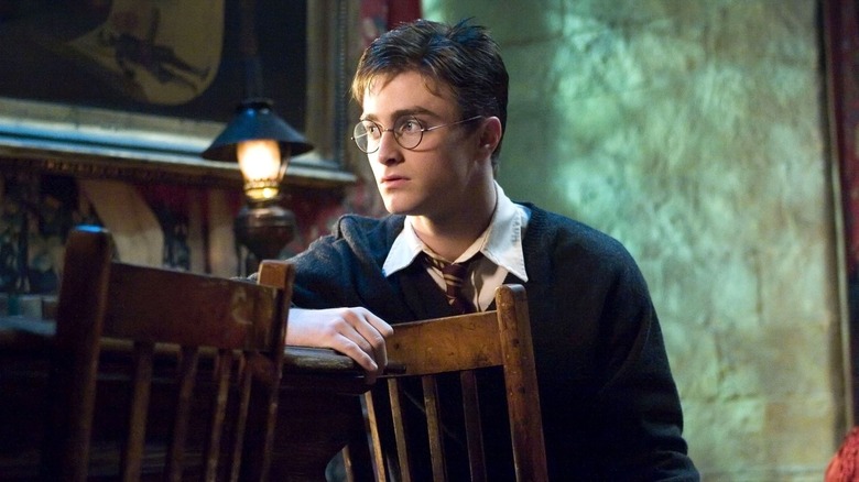 Harry sitting backwards on a chair and looking off to the side in Harry Potter and the Order of the Phoenix