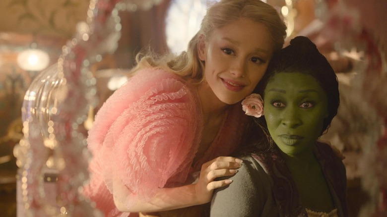 Cynthia Erivo's Elphaba and Ariana Grande's Glinda looking in the mirror together in Wicked