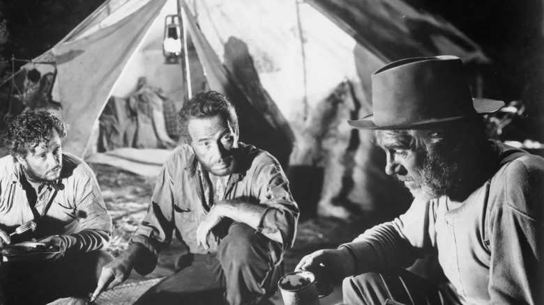 Fred, Bob, and Howard discussing the hidden gold in The Treasure of the Sierra Madre