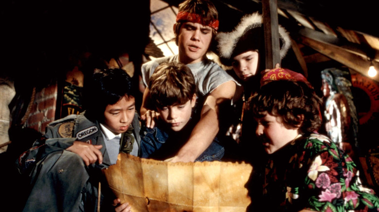 Data, Mikey, Chunk, Mouth and Brand looking at a pirate treasure map in The Goonies