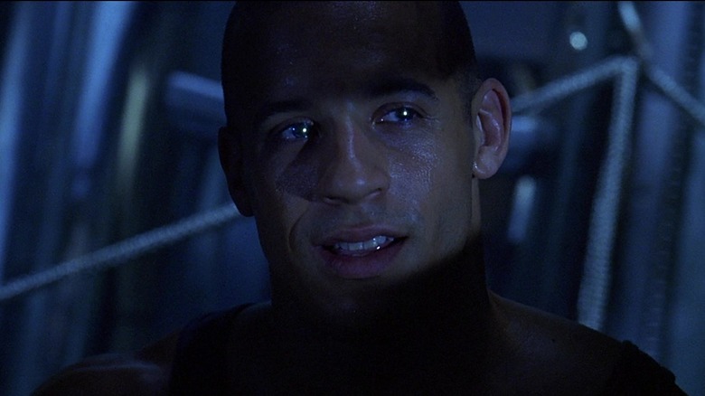 Pitch Black riddick smiling in shadows