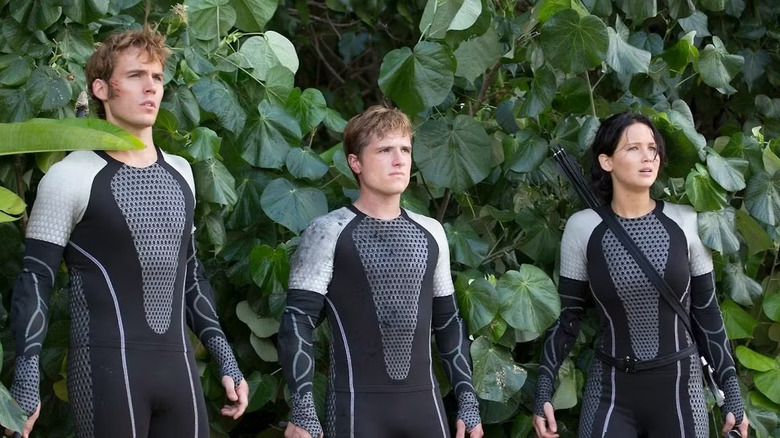 Finnick, Peeta, and Katniss on the arena beach in The Hunger Games: Catching Fire