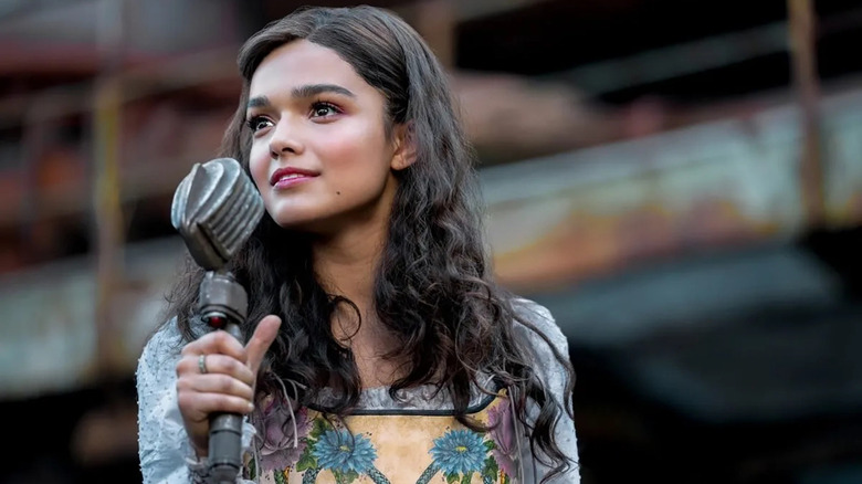 Lucy Gray Baird holding a microphone about to sing in The Hunger Games: The Ballad of Songbirds and Snakes