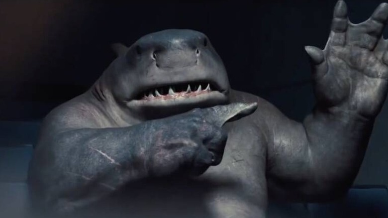 King Shark pointing to his own webbed hand in The Suicide Squad