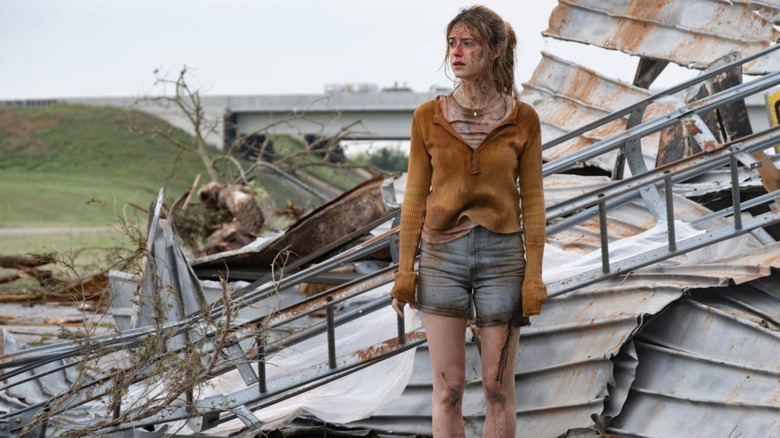 Kate standing in the rubble after a storm in Twisters