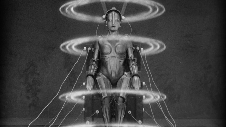 The robot Maria being brought to life in an eerie life-giving chair in Metropolis