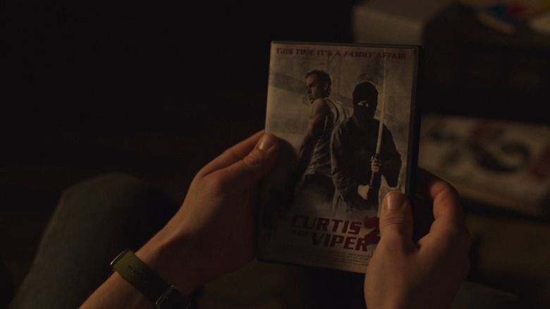 Pedro Pascal as Joel holding the Curtis and Viper 2 DVD in The Last of Us