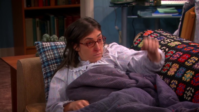 Amy sick on the couch on The Big Bang Theory