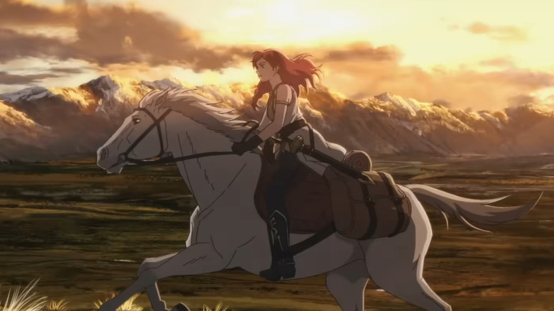 Hera riding a white horse against a mountain backdrop in The Lord of the Rings: The War of the Rohirrim