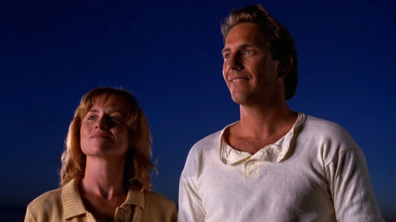 Kevin Costner as Ray Kinsella looking out on his baseball field with Amy Madigan as Karin Kinsella in Field of Dreams