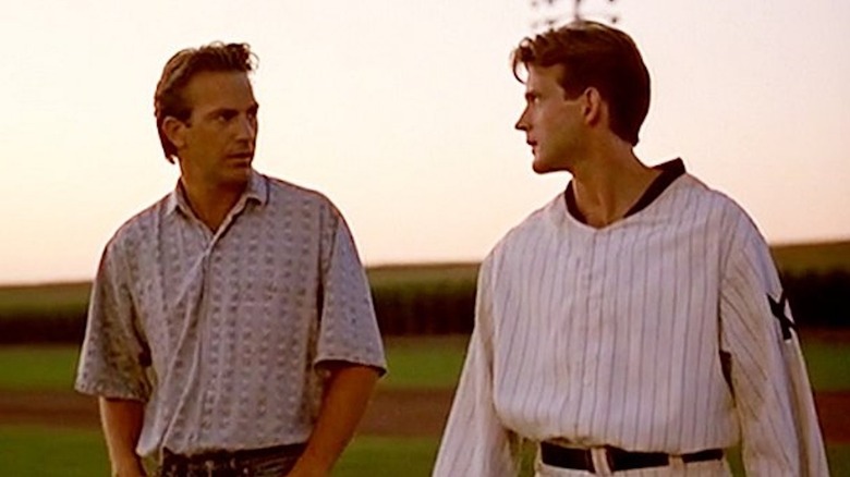 Kevin Costner as Ray Kinsella shares a catch with Dwyer Brown as John Kinsella in the film 