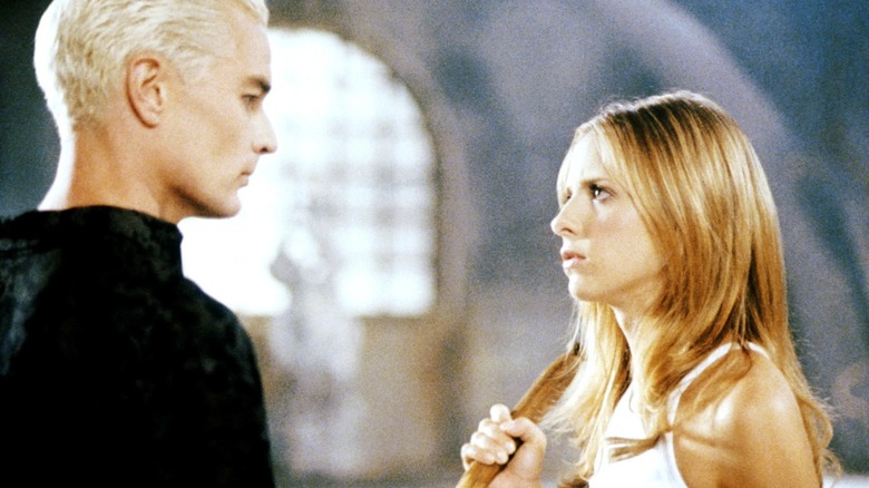 Spike and Buffy stare threateningly at each other