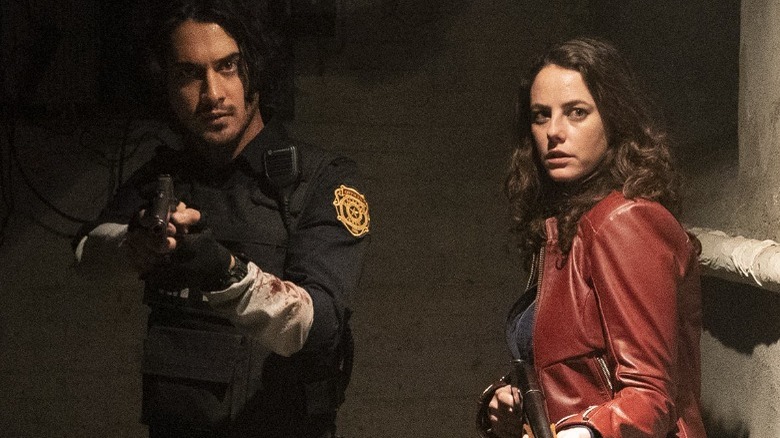 Kaya Scodelario and Avan Jogia holding guns