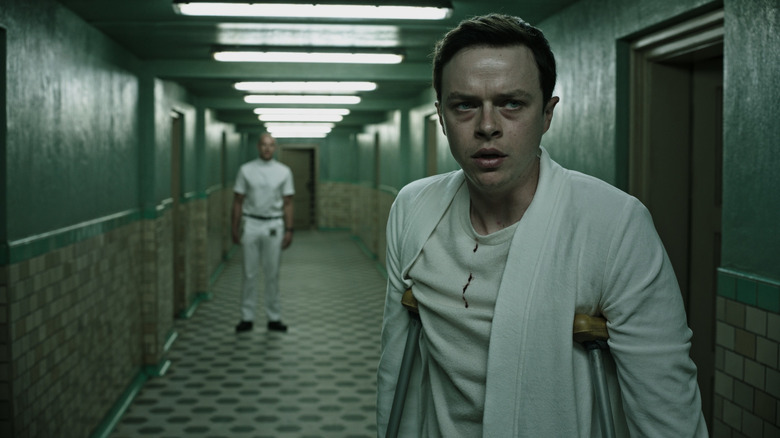 Man on crutches in hallway in A Cure For Wellness