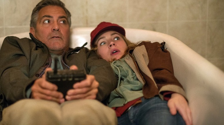 George Clooney and Britt Robertson hiding from villains