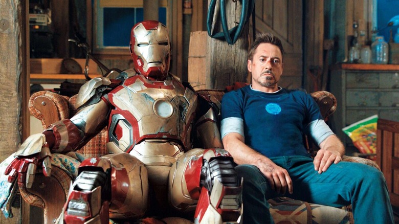 Tony Stark sitting aside armor