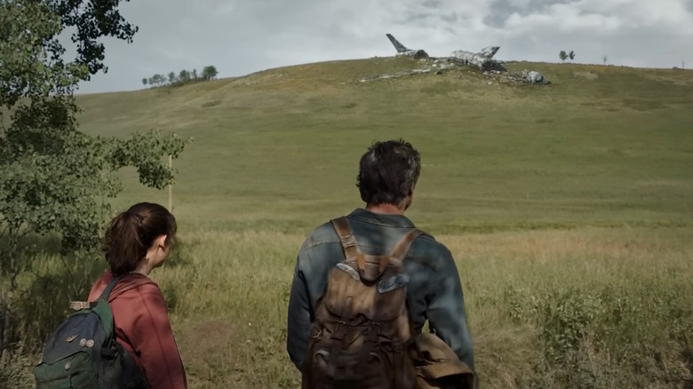 Joel and Ellie look at an airplane