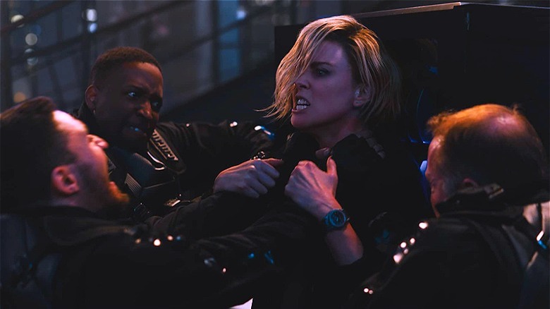 Charlize Theron fights several bad guys