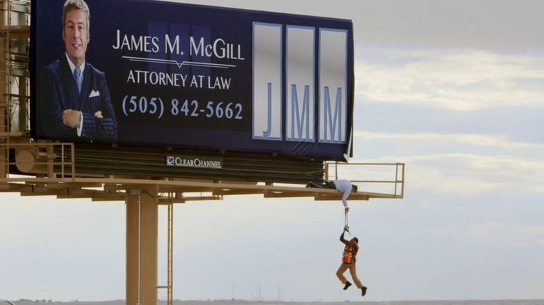 Worker hangs off billboard