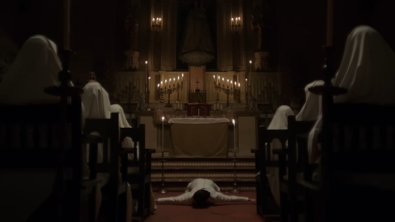 Person lying on the floor during a church service in Sister Death