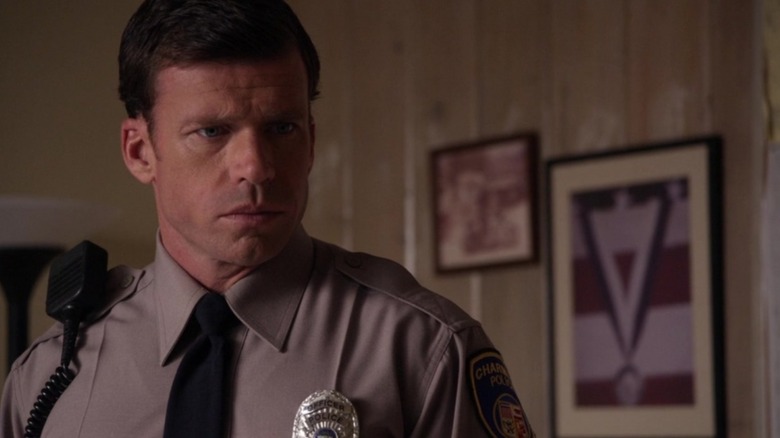 Taylor Sheridan's Deputy Hale, in uniform, stares seriously at something in Sons of Anarchy