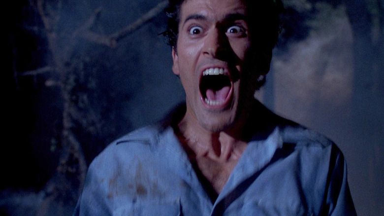 Bruce Campbell as Ash Williams screaming in Evil Dead 2