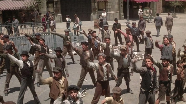 Jack Kelly and his fellow newsboys dancing in Newsies