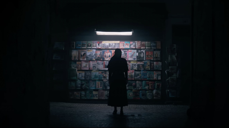 Woman looking at magazine rack in The Nun II