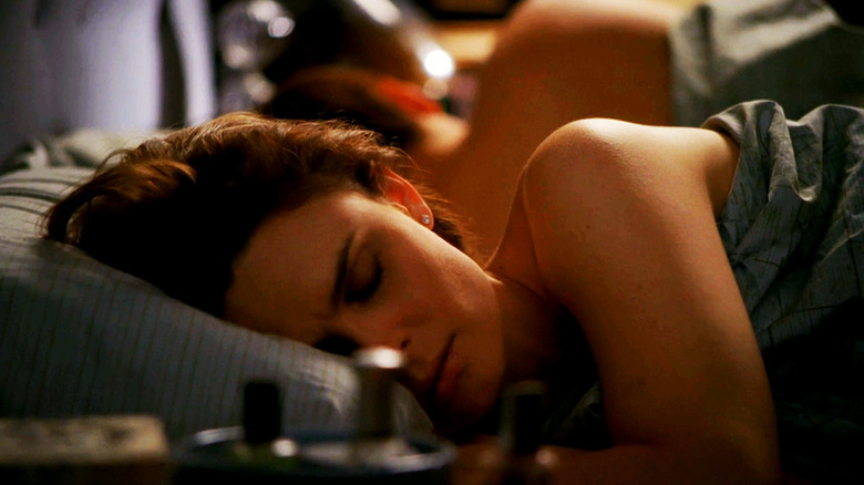 Emily Deschanel's Temperance Brennan lies in bed with David Boreanez's Seeley Booth seen in the background in Bones