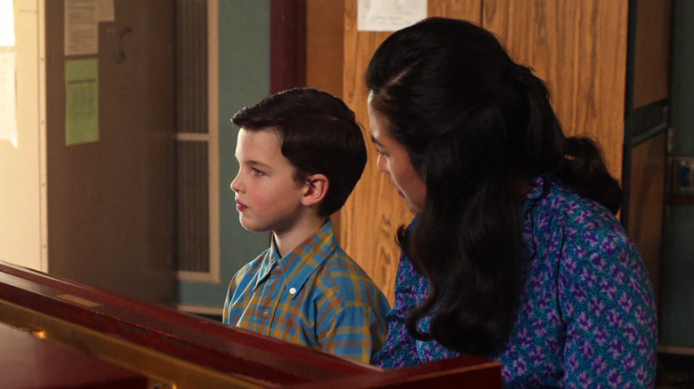 Sheldon sits on piano with Ms Fenley in the cockpit episode of Young Sheldon