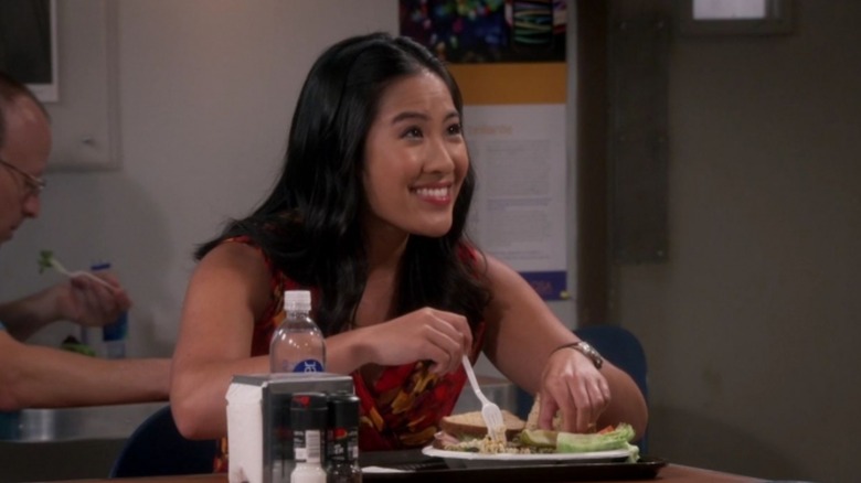 Melissa Tang's Mandy smiles while preparing to eat her lunch in The Big Bang Theory