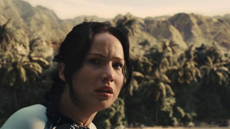 Katniss Everdeen scanning the Hunger Games arena in shock