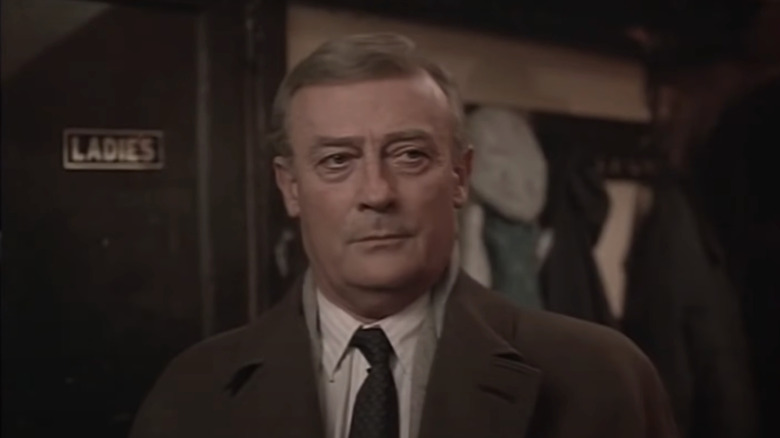 Edward Woodward's Robert McCall stands looking stern in The Equalizer